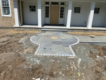Flagstone and cobblestone front entrance walkway with owners’ millstone (Newtown Square)