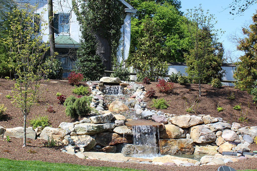 waterfall hardscaping in mulch bed